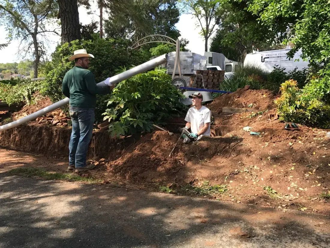 Crew replacing a sewer line on a foothills hillside